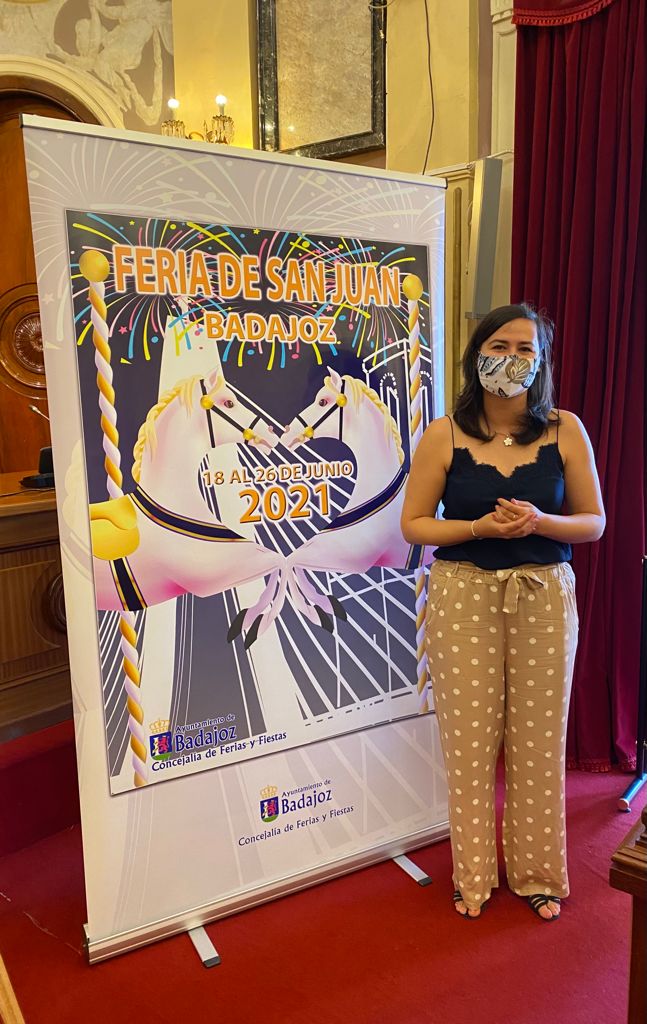 La concejala de festejos, Lara Montero de Espinosa, junto al cartel de la Feria de San Juan 2021.