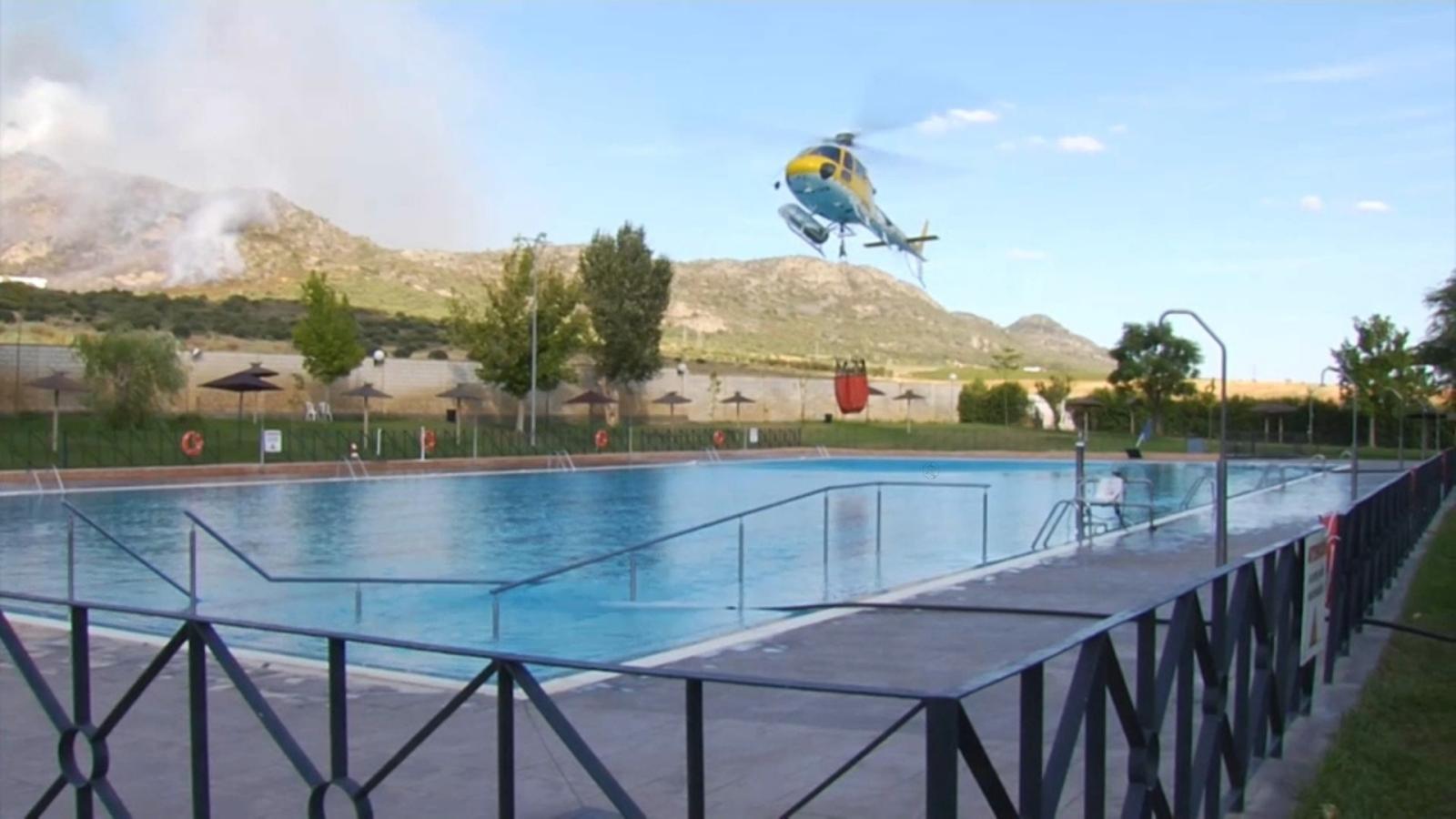 Helicóptero del INFOEX cargando agua de la piscina municipal de Arroyo de San Serván